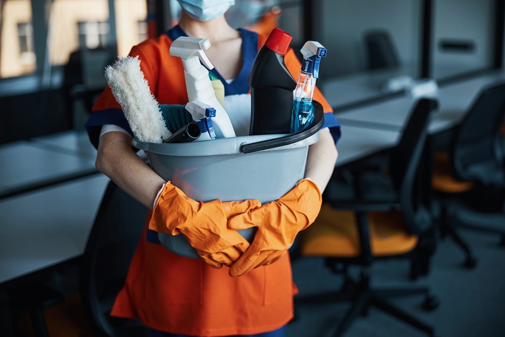 Holding a bucket of cleaning supplies