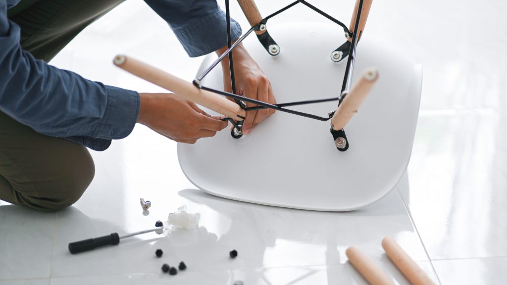 man assembling an office chair